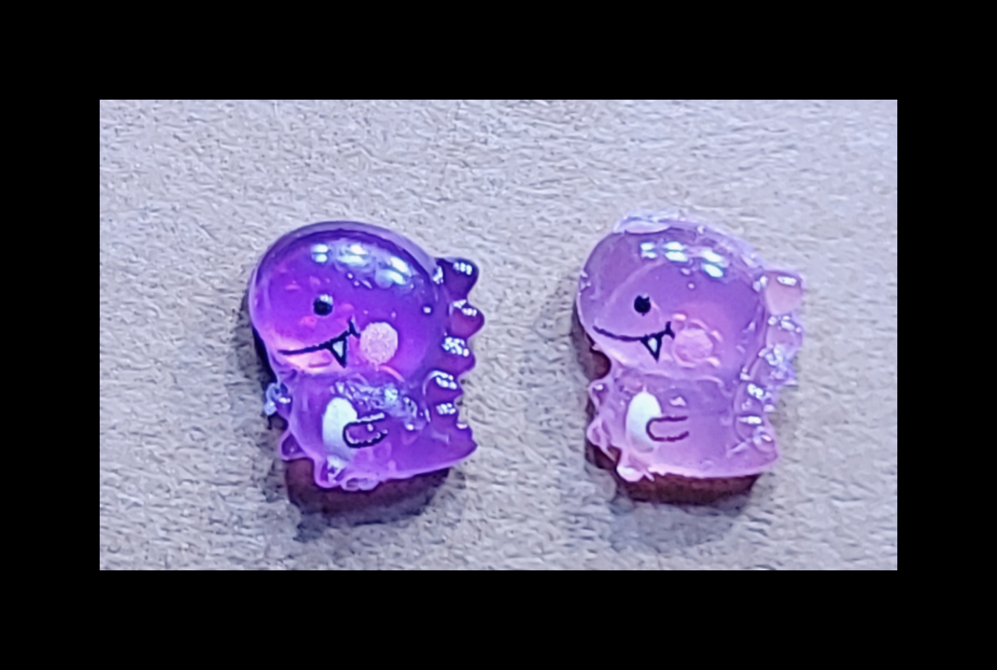 UV reactive dino stud earrings